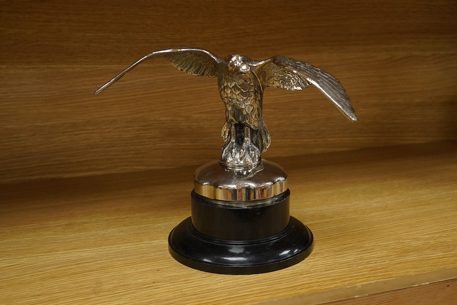 A large chromed eagle car mascot, mounted on a large radiator cap and turned socle, height 21.5cm. Condition - good.